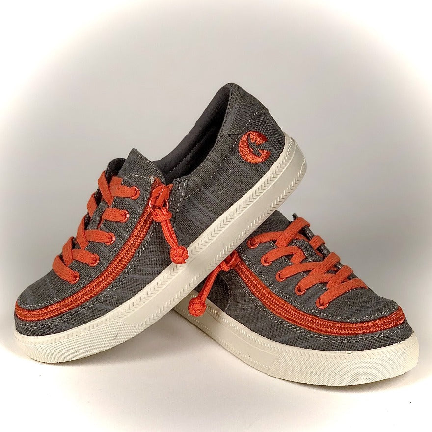 Kid's Grey/Orange BILLY Classic Lace Lows, zipper shoes, like velcro, that are adaptive, accessible, inclusive and use universal design to accommodate an afo. Footwear is medium and wide width, M, D and EEE, are comfortable, and come in toddler, kids, mens, and womens sizing.