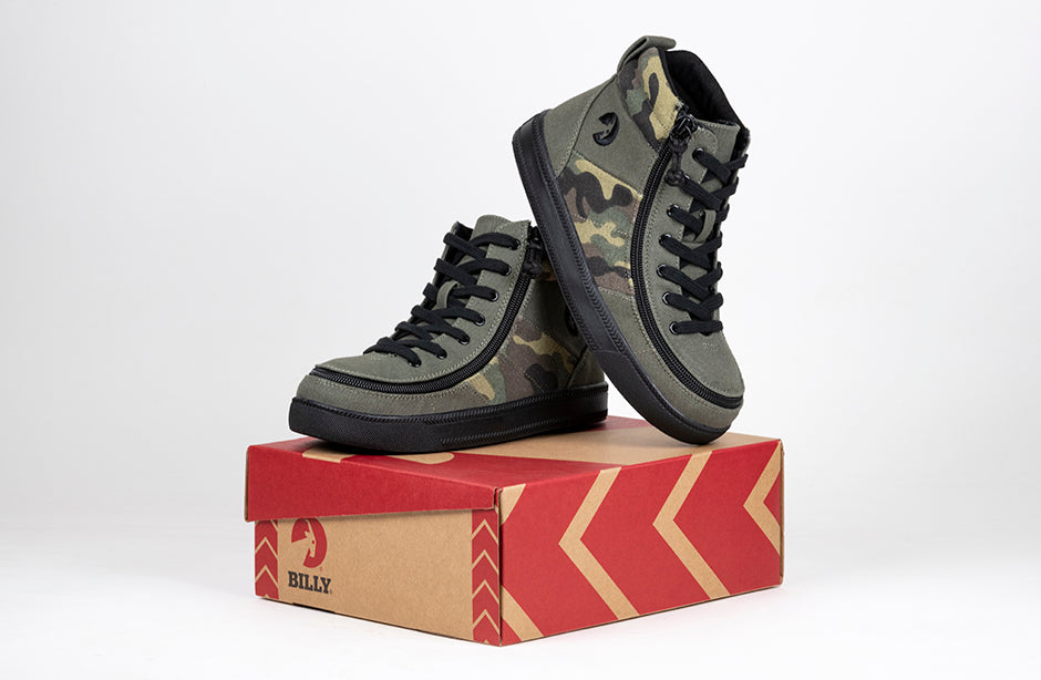 Kid's Olive Camo BILLY Street High Tops, zipper shoes, like velcro, that are adaptive, accessible, inclusive and use universal design to accommodate an afo. BILLY Footwear comes in medium and wide width, M, D and EEE, are comfortable, and come in toddler, kids, mens, and womens sizing.