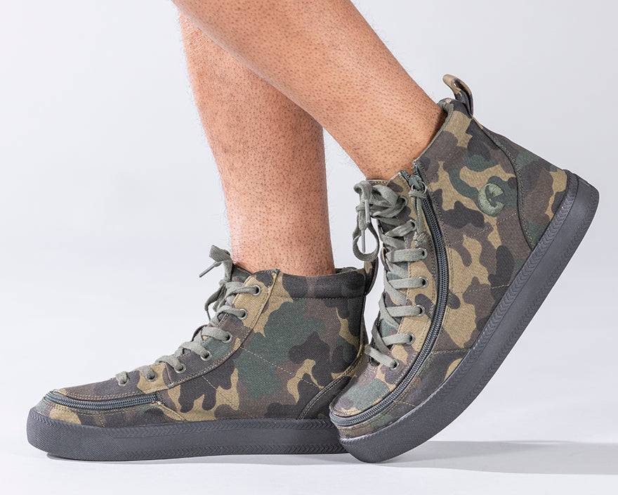 Men's Green Camo BILLY Classic Lace Highs, zipper shoes, like velcro, that are adaptive, accessible, inclusive and use universal design to accommodate an afo. Footwear is medium and wide width, M, D and EEE, are comfortable, and come in toddler, kids, mens, and womens sizing.