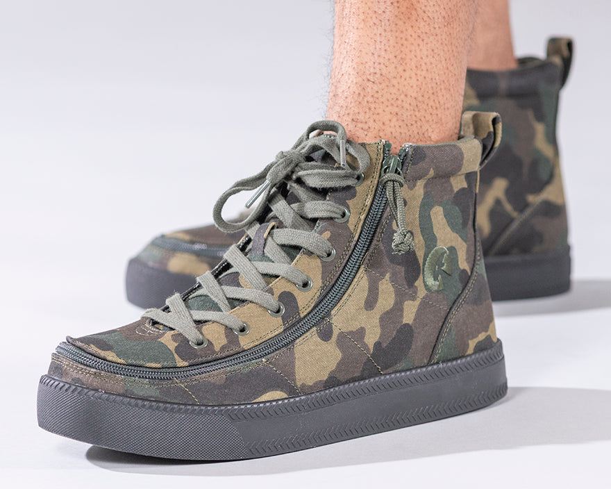 Men's Green Camo BILLY Classic Lace Highs, zipper shoes, like velcro, that are adaptive, accessible, inclusive and use universal design to accommodate an afo. Footwear is medium and wide width, M, D and EEE, are comfortable, and come in toddler, kids, mens, and womens sizing.